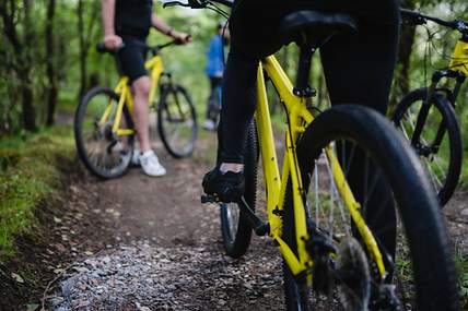 Ein junges Paar fährt Fahrrad und ist mit einer Versicherung gegen einen Fahrradunfall abgesichert. 