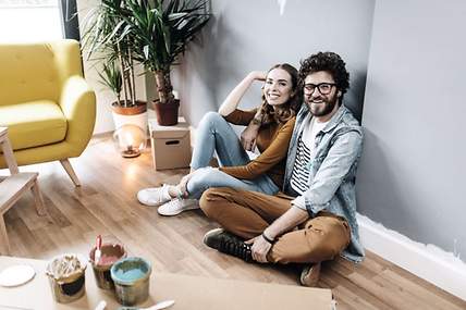 Das Bild zeigt ein junges Paar in ihrer Wohnung.