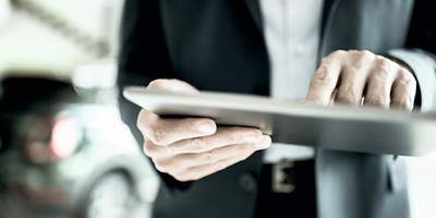 Derivate: Erklärung von Termingeschäften Person, die an einem Tablet Derivate erklärt