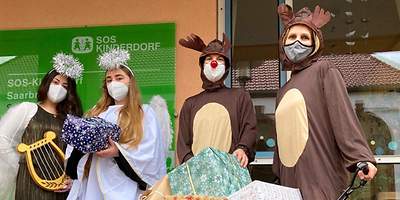 Vier verkleidete Menschen mit Geschenken