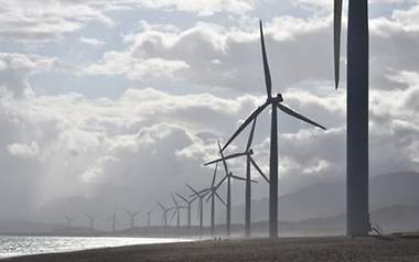 Viele Windräder an einer Küste.